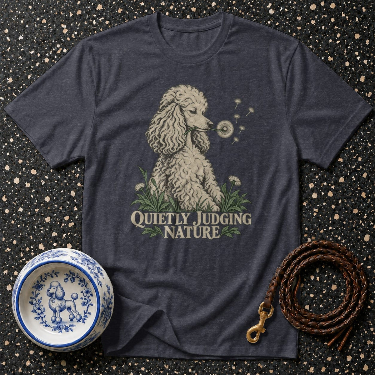 Dark grey t-shirt with poodle blowing dandelion seeds and text "Quietly Judging Nature."