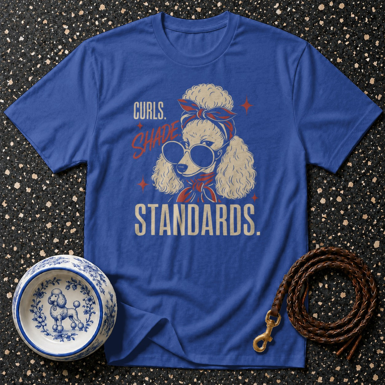 Blue t-shirt with a graphic of a poodle wearing sunglasses and a bandana, text "Curls. Shade. Standards."