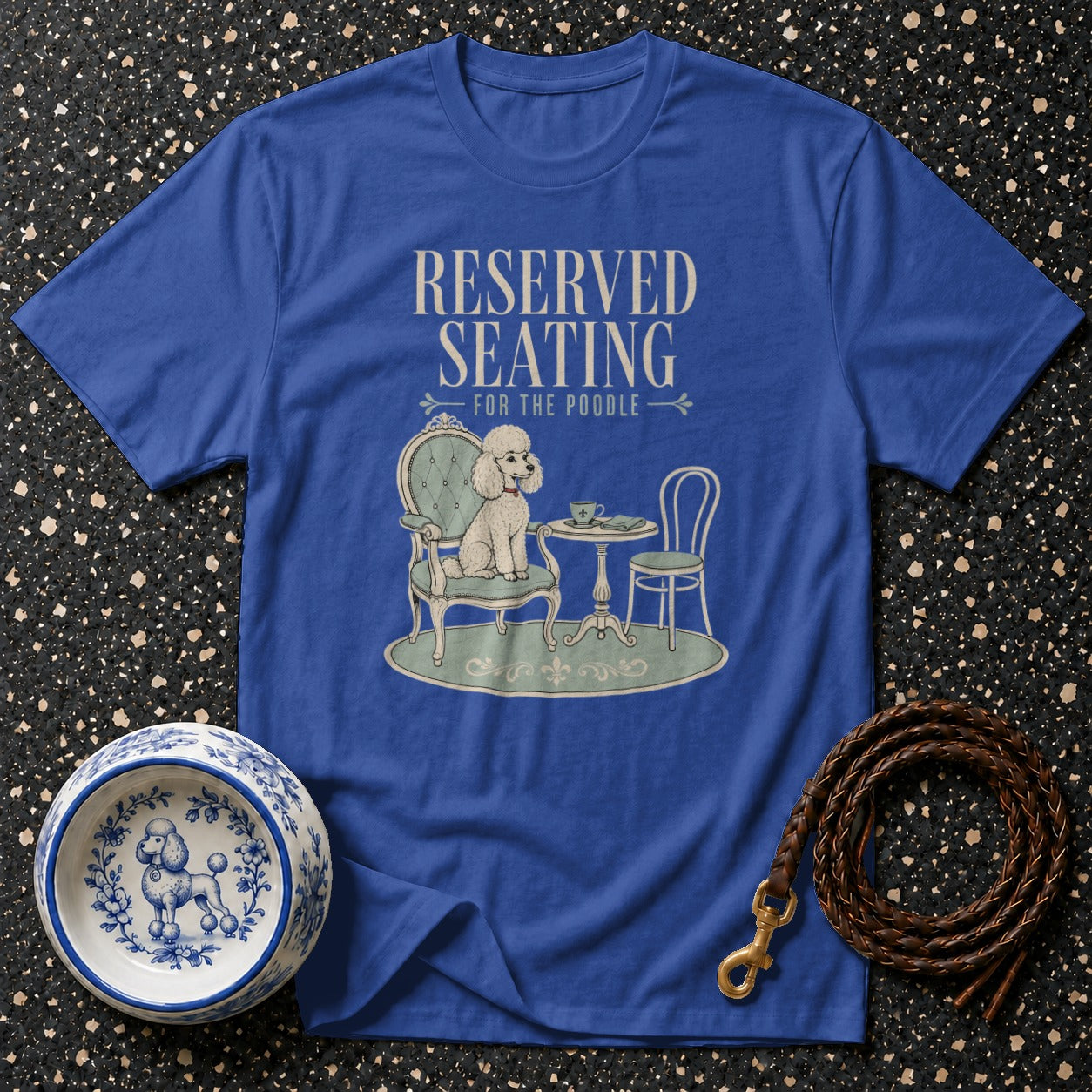 Blue t-shirt featuring a poodle sitting at a table with text "RESERVED SEATING FOR THE POODLE".