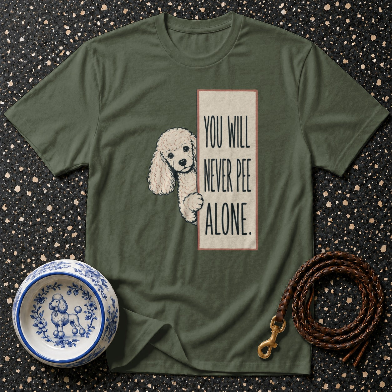 Olive green t-shirt with poodle graphic and text "You Will Never Pee Alone."