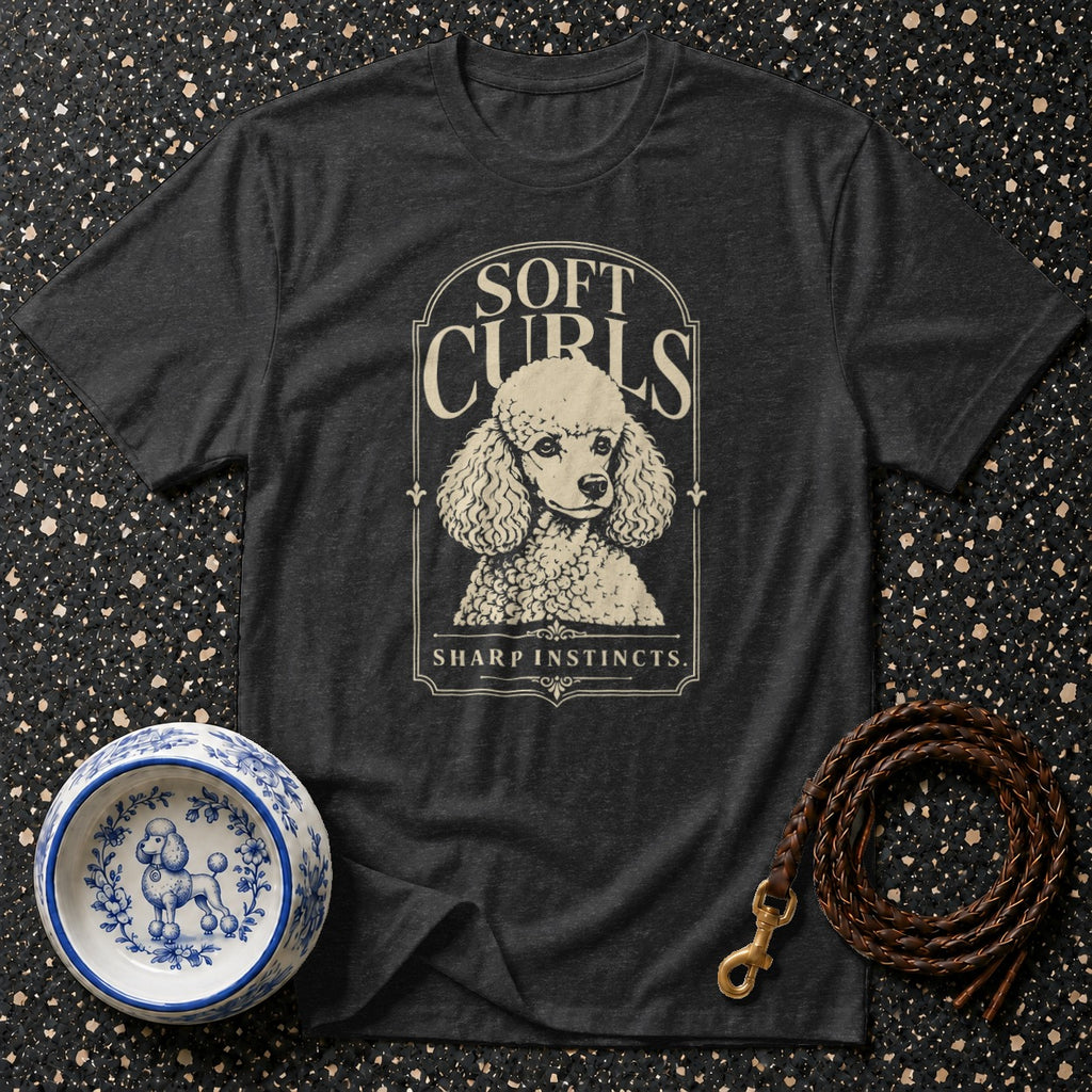 Dark gray t-shirt with a poodle graphic and text "SOFT CURLS SHARP INSTINCTS".