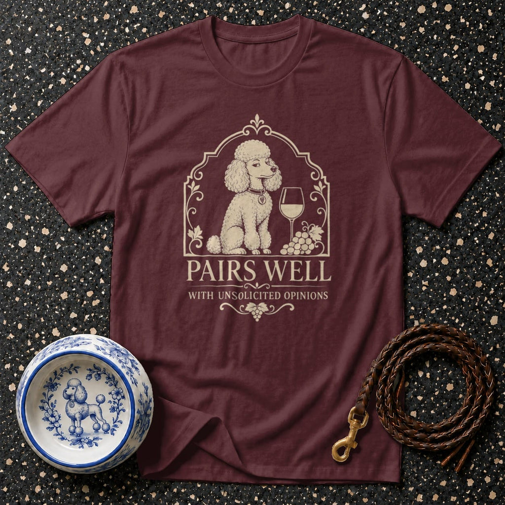 Maroon t-shirt with a poodle, wine glass, grapes, and text: Pairs Well With Unsolicited Opinions.