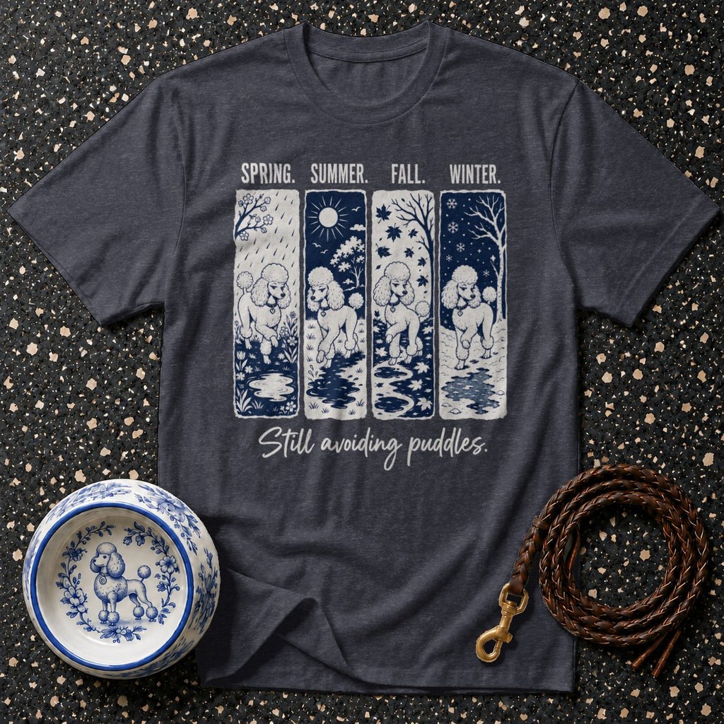 Dark t-shirt with a graphic of four poodles in spring, summer, fall, and winter scenes.
