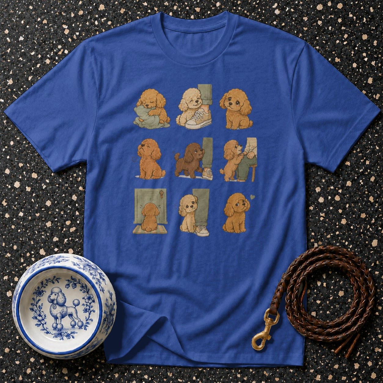 Blue t-shirt with nine illustrations of adorable puppies in various playful scenarios.