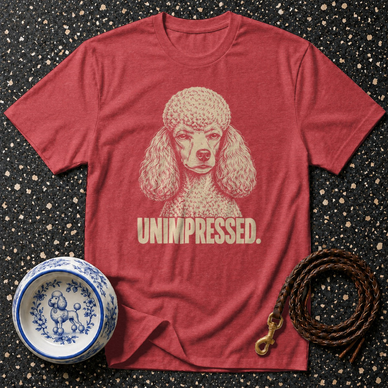 Red t-shirt with a poodle graphic and the word "UNIMPRESSED."