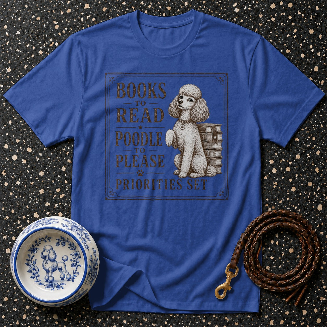 Blue t-shirt with poodle illustration and text "Books to Read, Poodle to Please, Priorities Set".