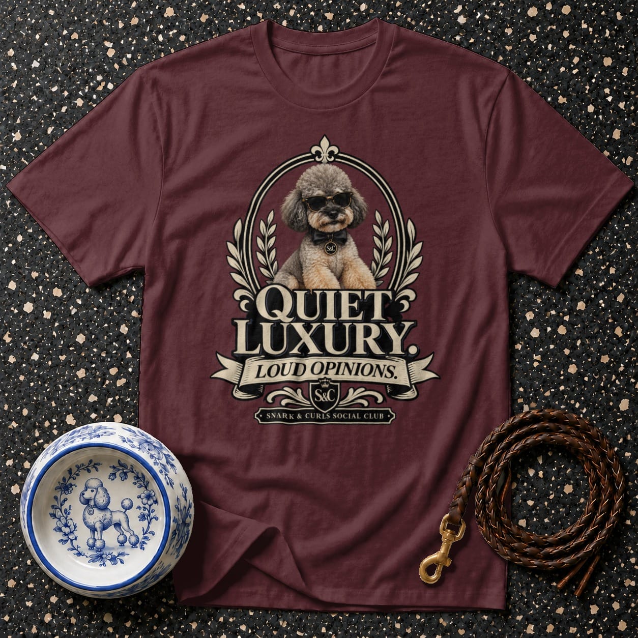 Maroon t-shirt with a poodle wearing sunglasses and the text "Quiet Luxury Loud Opinions".