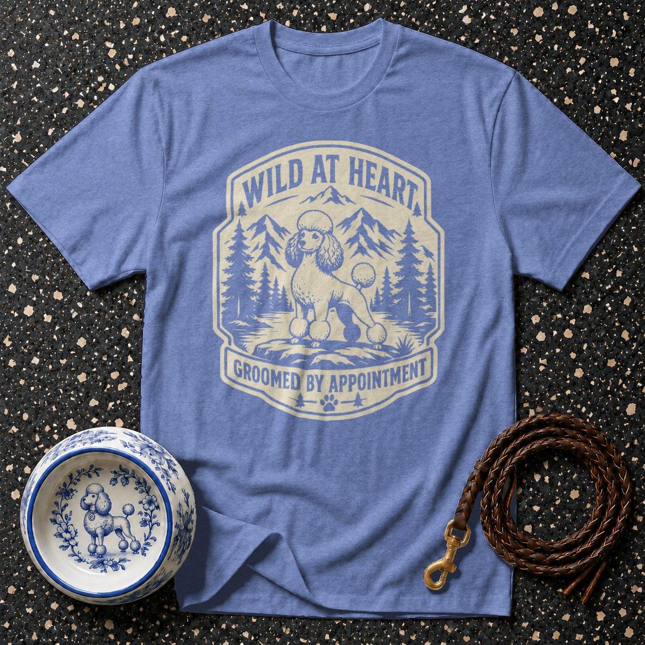 Blue t-shirt with poodle graphic and text "WILD AT HEART GROOMED BY APPOINTMENT".