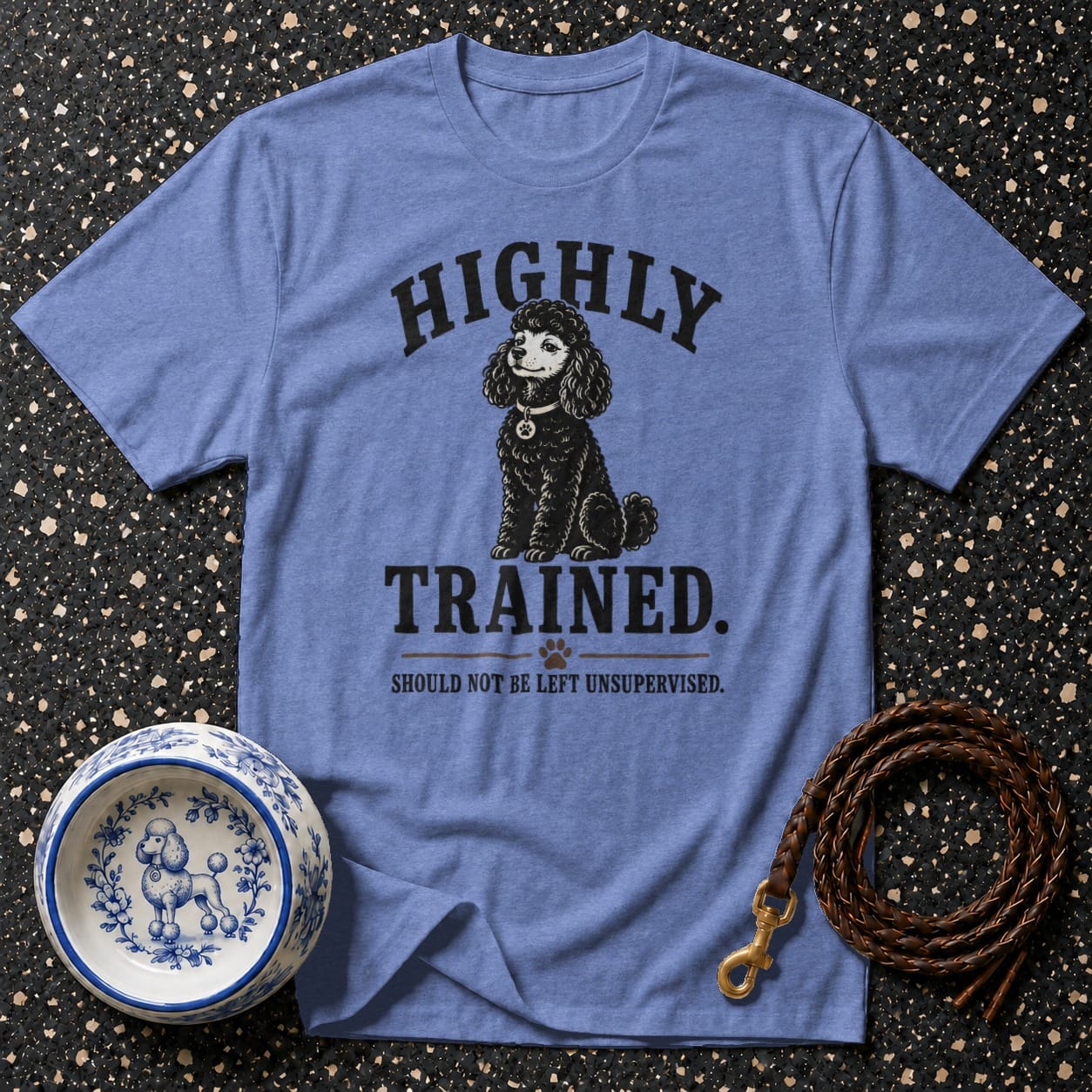 Blue t-shirt with black poodle illustration and text "HIGHLY TRAINED. SHOULD NOT BE LEFT UNSUPERVISED."