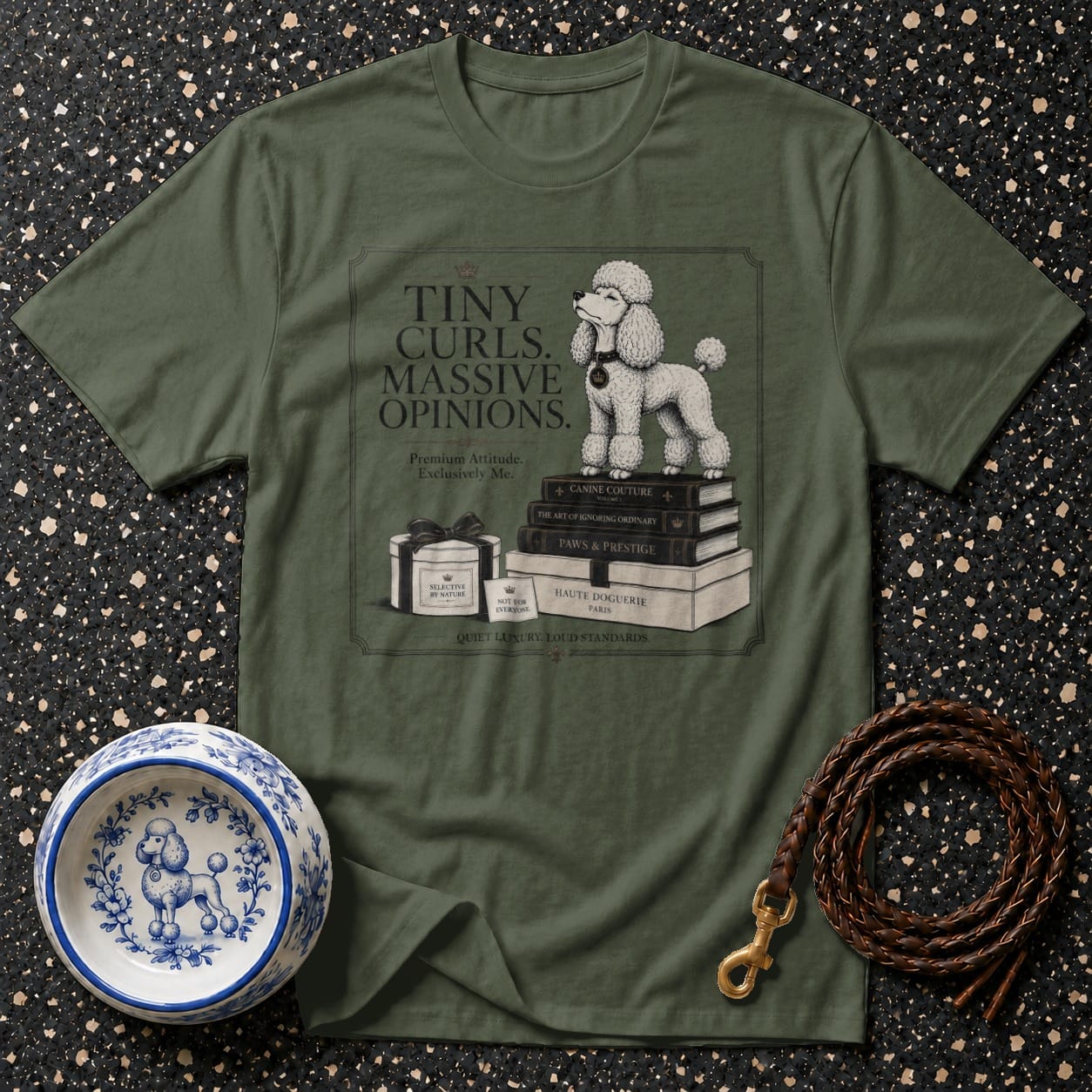 Green t-shirt with illustration of poodle on books, "Tiny Curls. Massive Opinions." text.