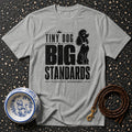 Grey t-shirt with black text and poodle graphic: "Tiny Dog Big Standards Please Act Accordingly."