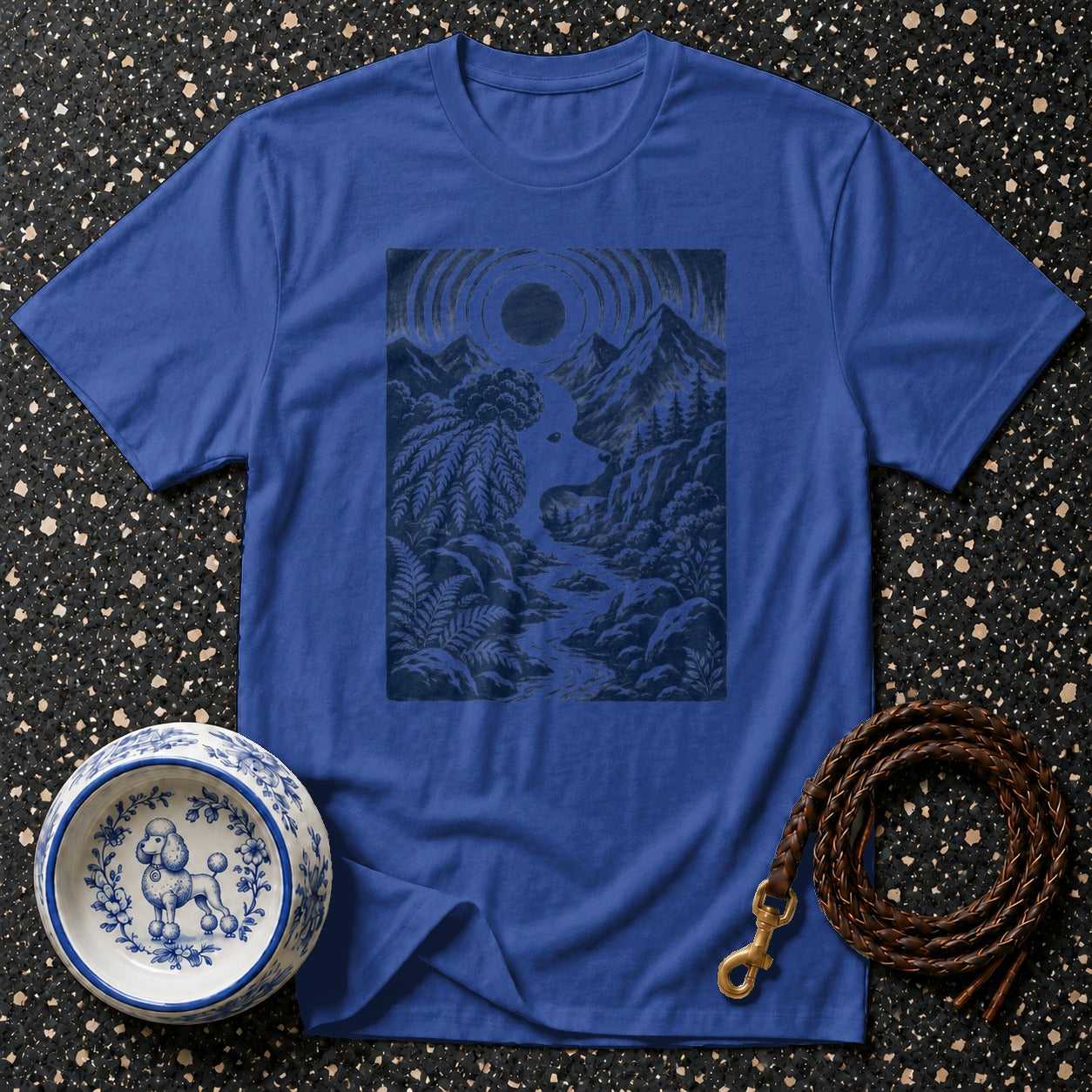 Blue t-shirt with a dark blue mountain and river landscape graphic.