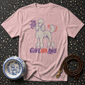 Pink t-shirt with poodle graphic and text "The Tail Gave Her Away."