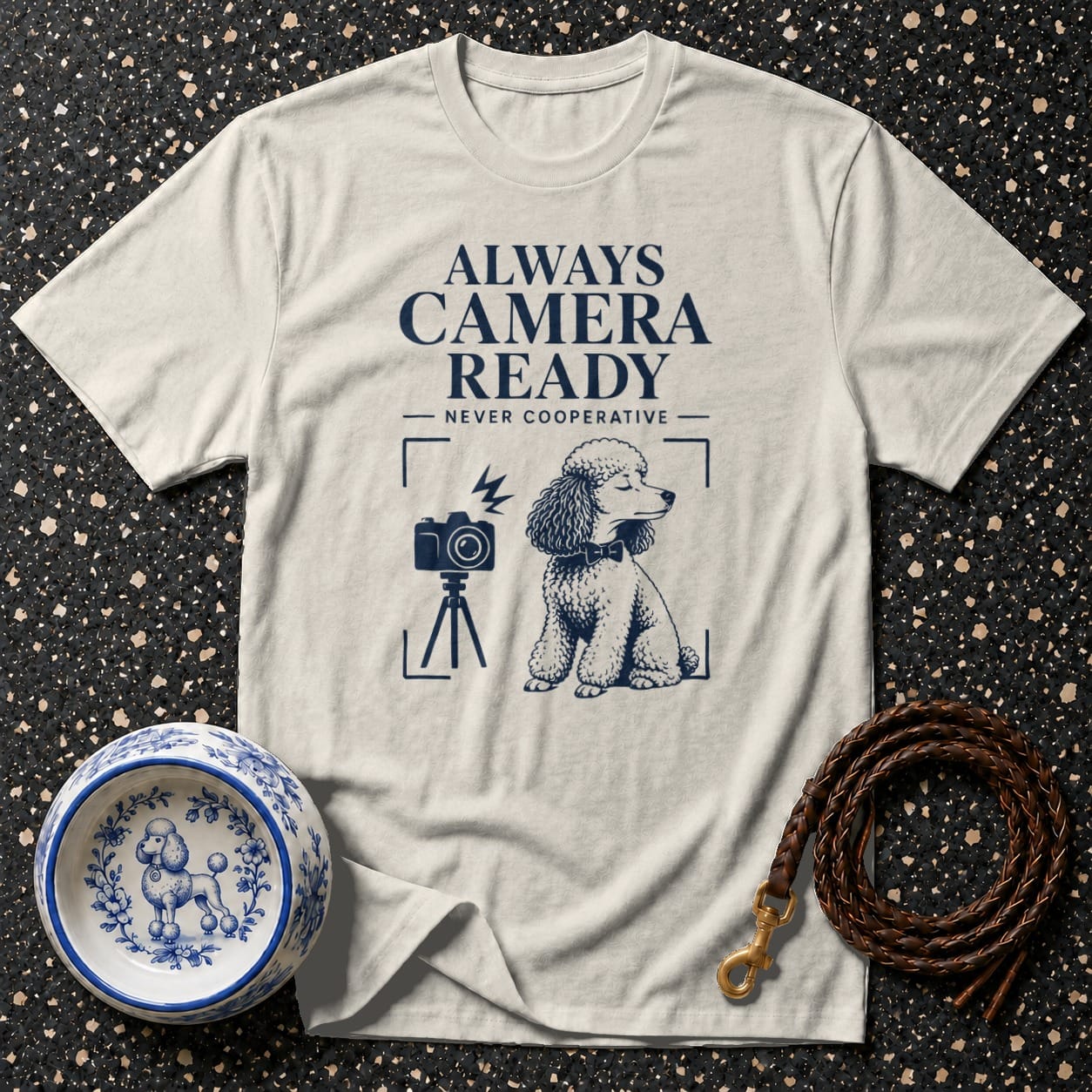 Light gray t-shirt with "ALWAYS CAMERA READY NEVER COOPERATIVE" text and poodle graphic.