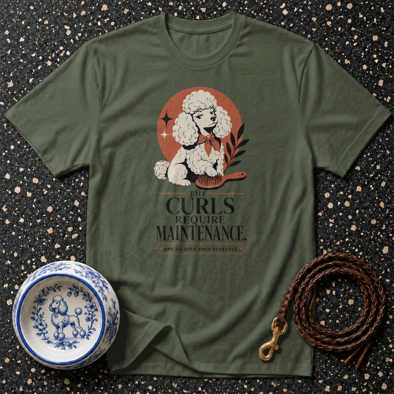 Green t-shirt with poodle graphic and text "THE CURLS REQUIRE MAINTENANCE. AND SO DOES YOUR SCHEDULE."