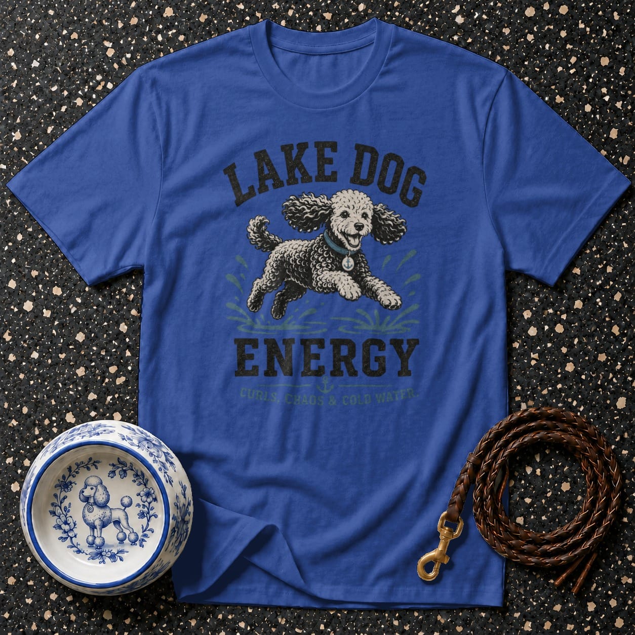 Blue t-shirt with "Lake Dog Energy" text and poodle graphic, dog bowl and leash.