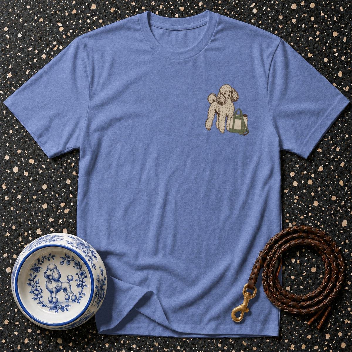 Blue t-shirt with a poodle and tote bag graphic on the chest.