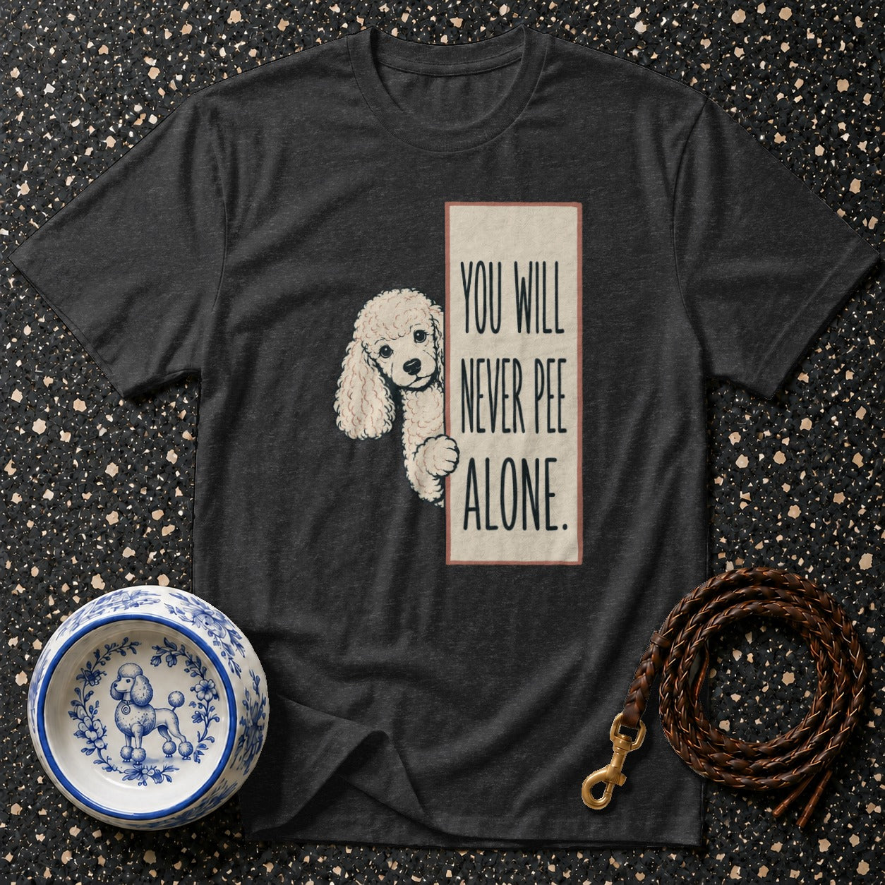 Dark t-shirt with poodle graphic and text "You will never pee alone."