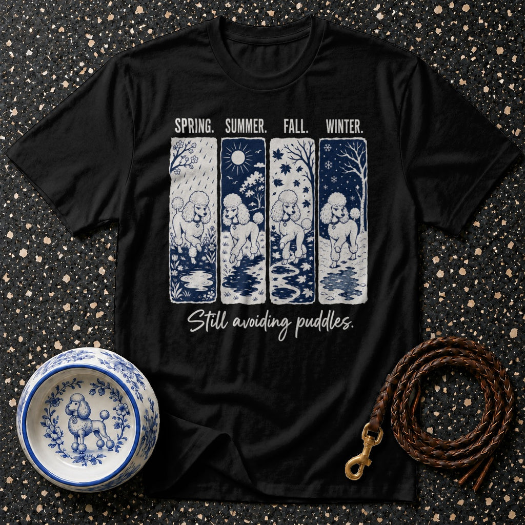 Black t-shirt with four panels showing poodles in different seasons, "Still avoiding puddles."