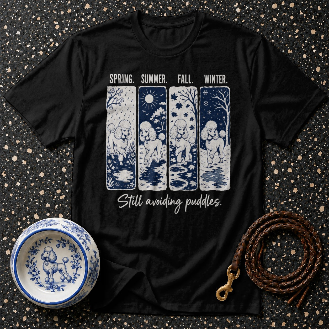 Black t-shirt with four panels showing poodles in different seasons, "Still avoiding puddles."