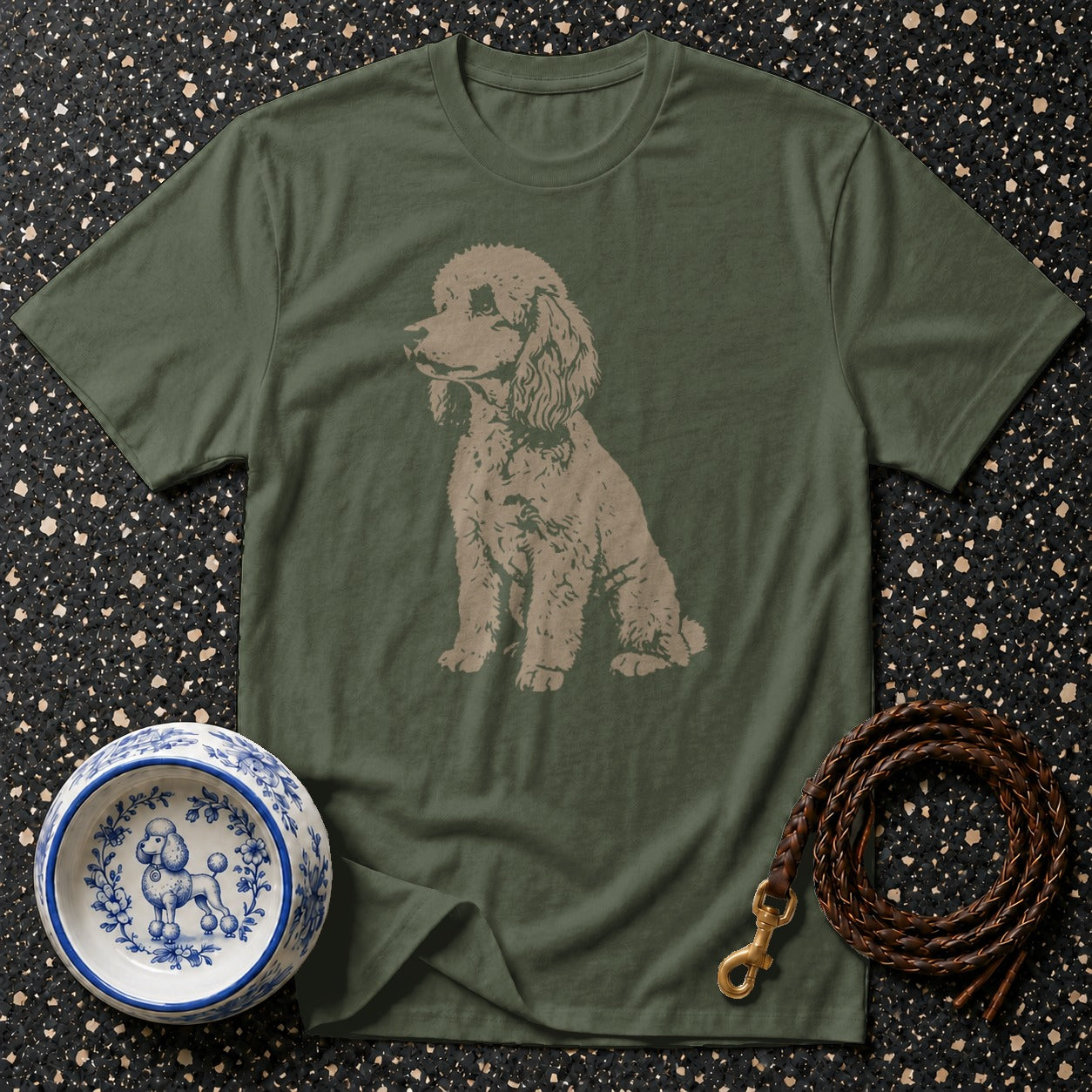Olive green t-shirt with a tan poodle graphic, decorative dog bowl, and braided leather leash.