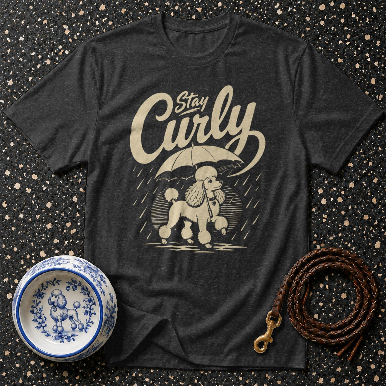 Dark t-shirt with a poodle and umbrella graphic that says "Stay Curly".