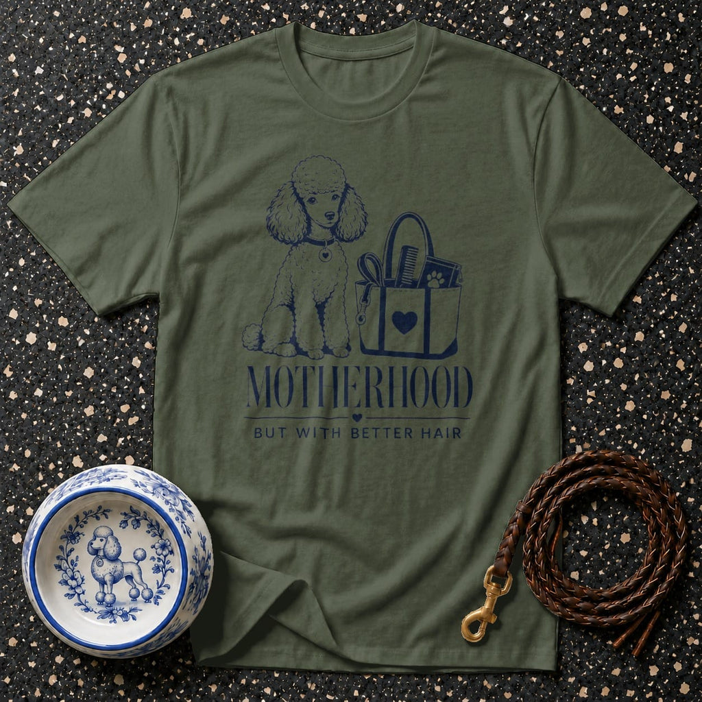 Green t-shirt with a poodle, grooming bag, and text: Motherhood but with better hair.