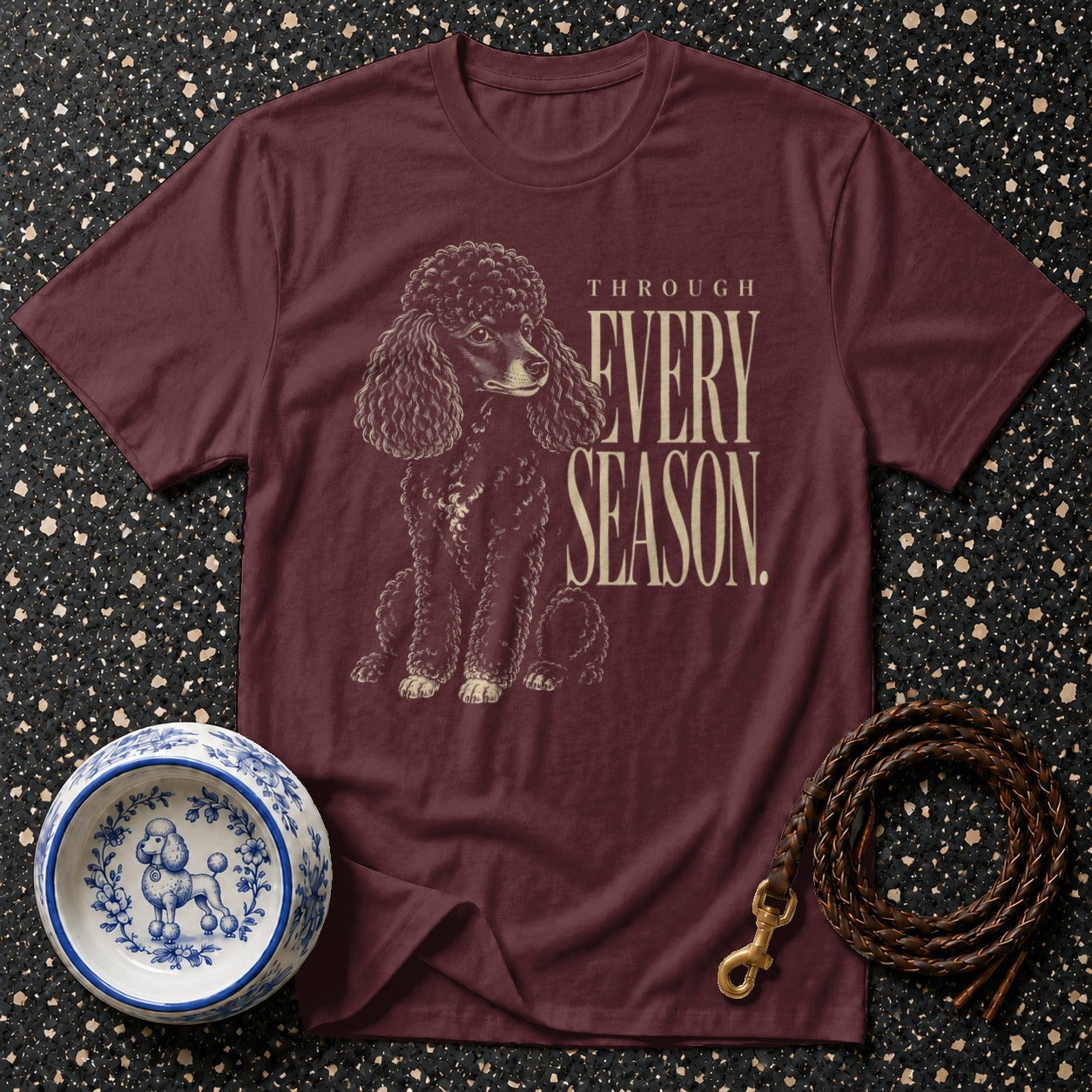 Burgundy t-shirt with a poodle graphic and text "THROUGH EVERY SEASON".