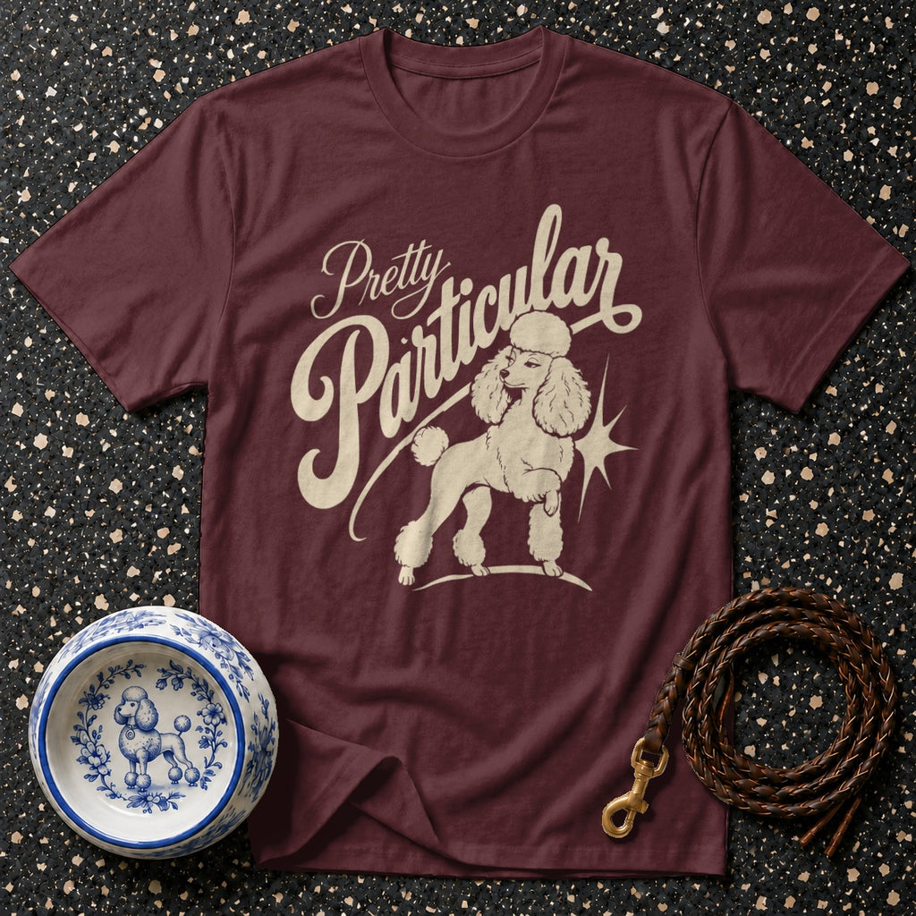 Maroon t-shirt with "Pretty Particular" text and poodle graphic.
