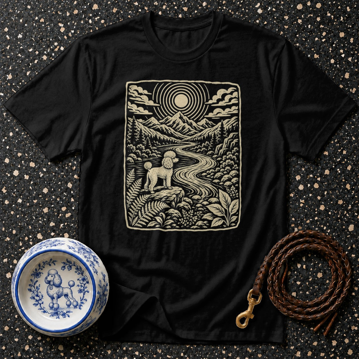 Black t-shirt with poodle in a mountainous landscape print.