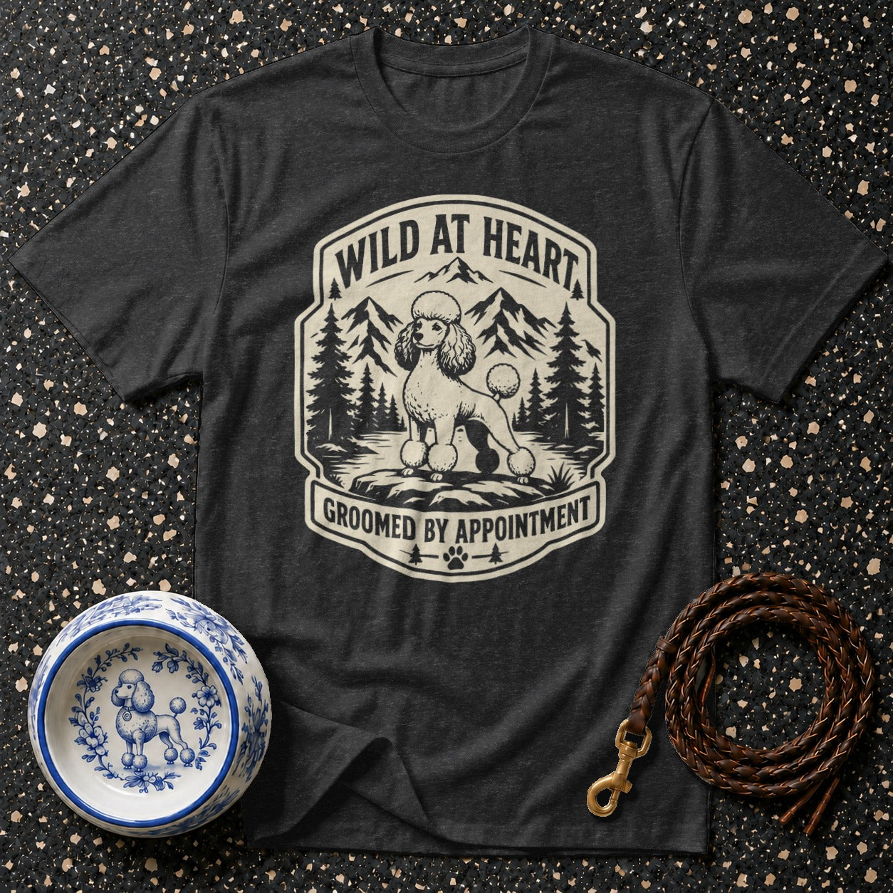 Dark grey t-shirt with a vintage-style poodle graphic and text "Wild at Heart, Groomed by Appointment."