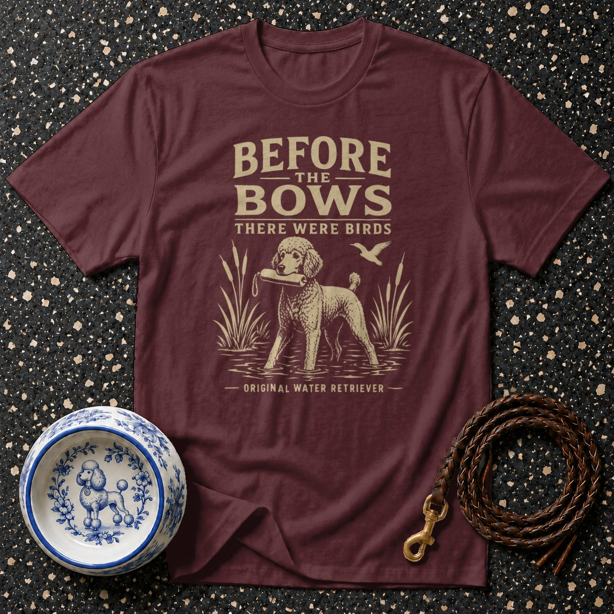 Maroon t-shirt with text and illustration of a dog retrieving a bird.