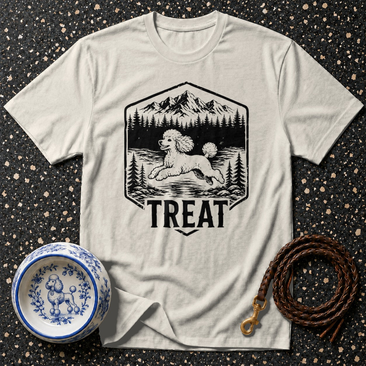 White t-shirt with a black graphic of a poodle running in a forest scene, text reads "TREAT".