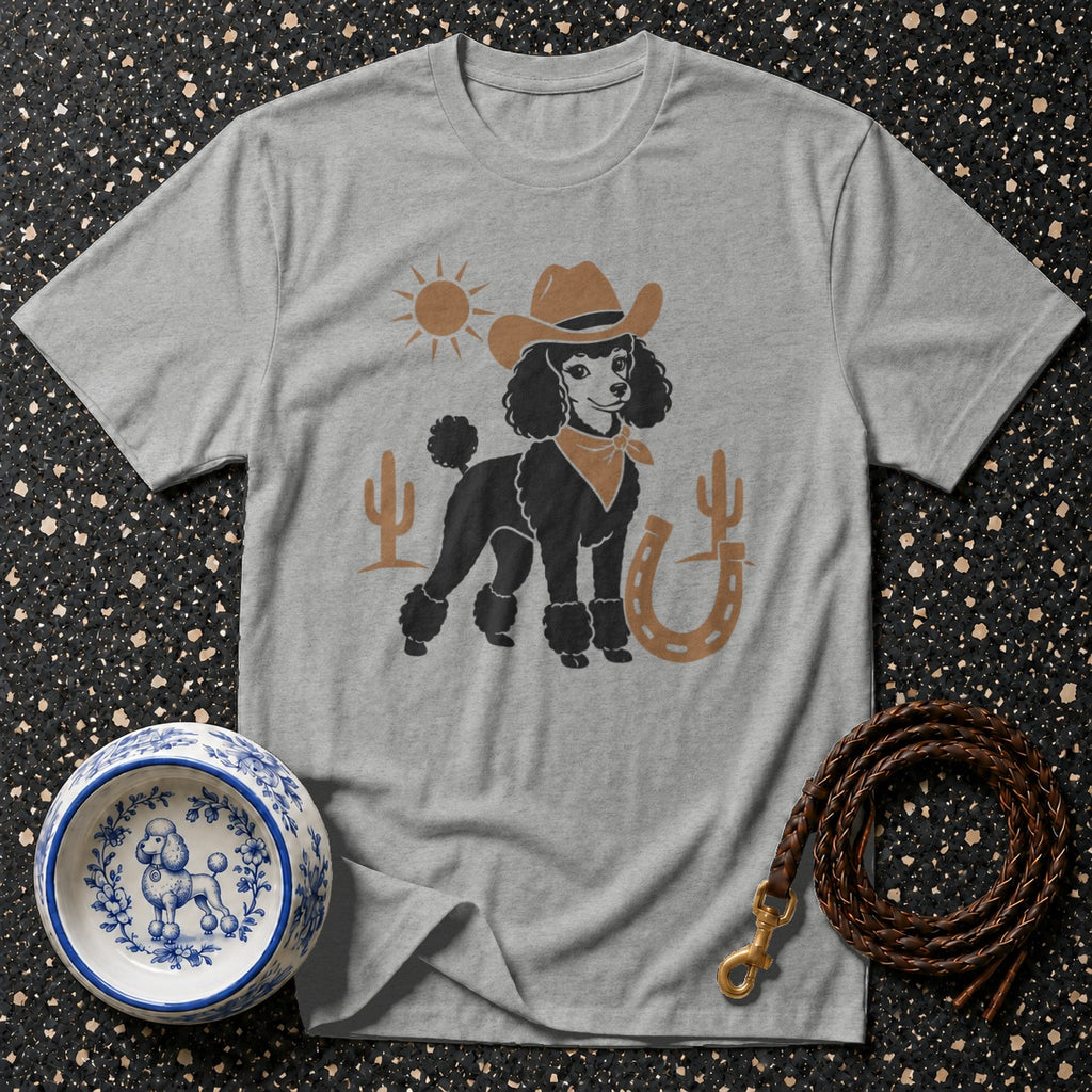 Grey t-shirt featuring a black poodle in a cowboy hat and bandana on a desert background.