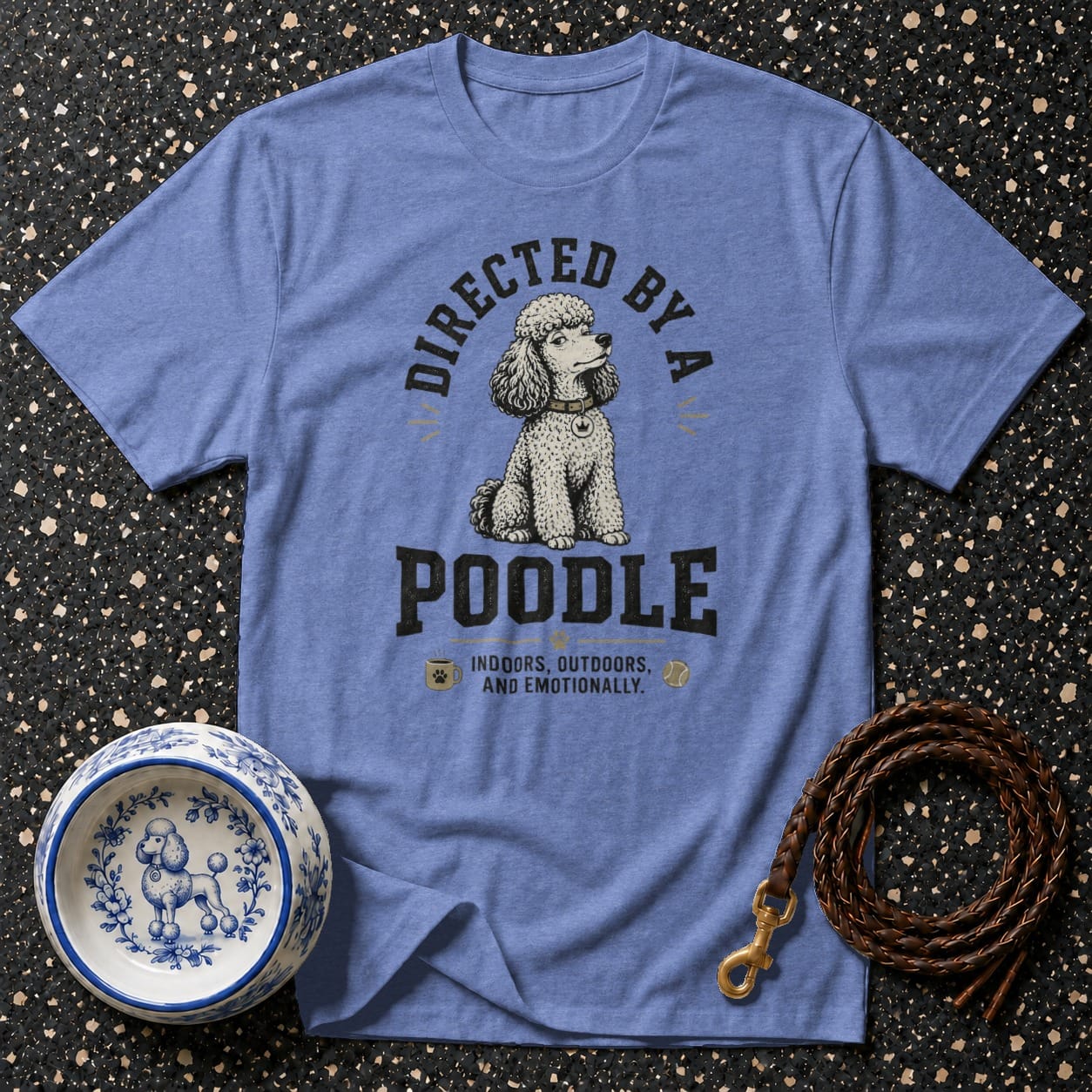 Blue t-shirt with "Directed by a Poodle" graphic and dog accessories.
