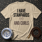 Tan t-shirt with "I HAVE STANDARDS AND CURLS" and a poodle illustration.