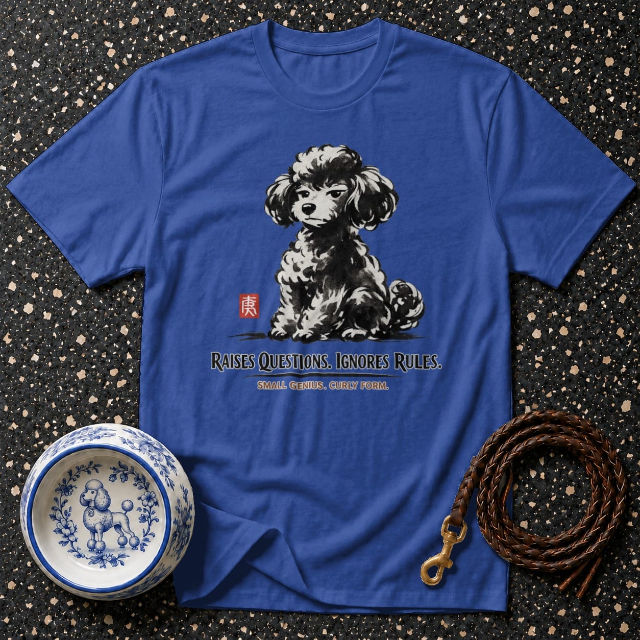 Blue t-shirt with a black and white poodle graphic and text "RAISES QUESTIONS. IGNORES RULES. SMALL GENIUS. CURLY FORM."