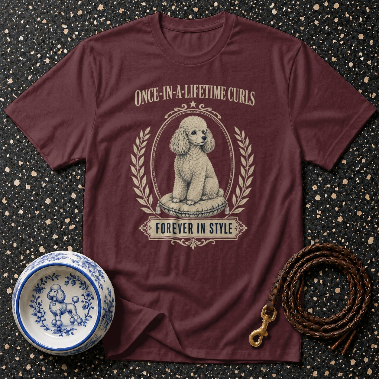 Maroon t-shirt with a poodle graphic and text: "Once-in-a-lifetime curls, forever in style."