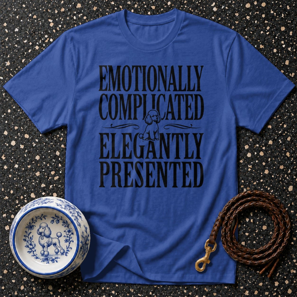 Blue t-shirt with text "Emotionally Complicated Elegantly Presented" and poodle graphic.