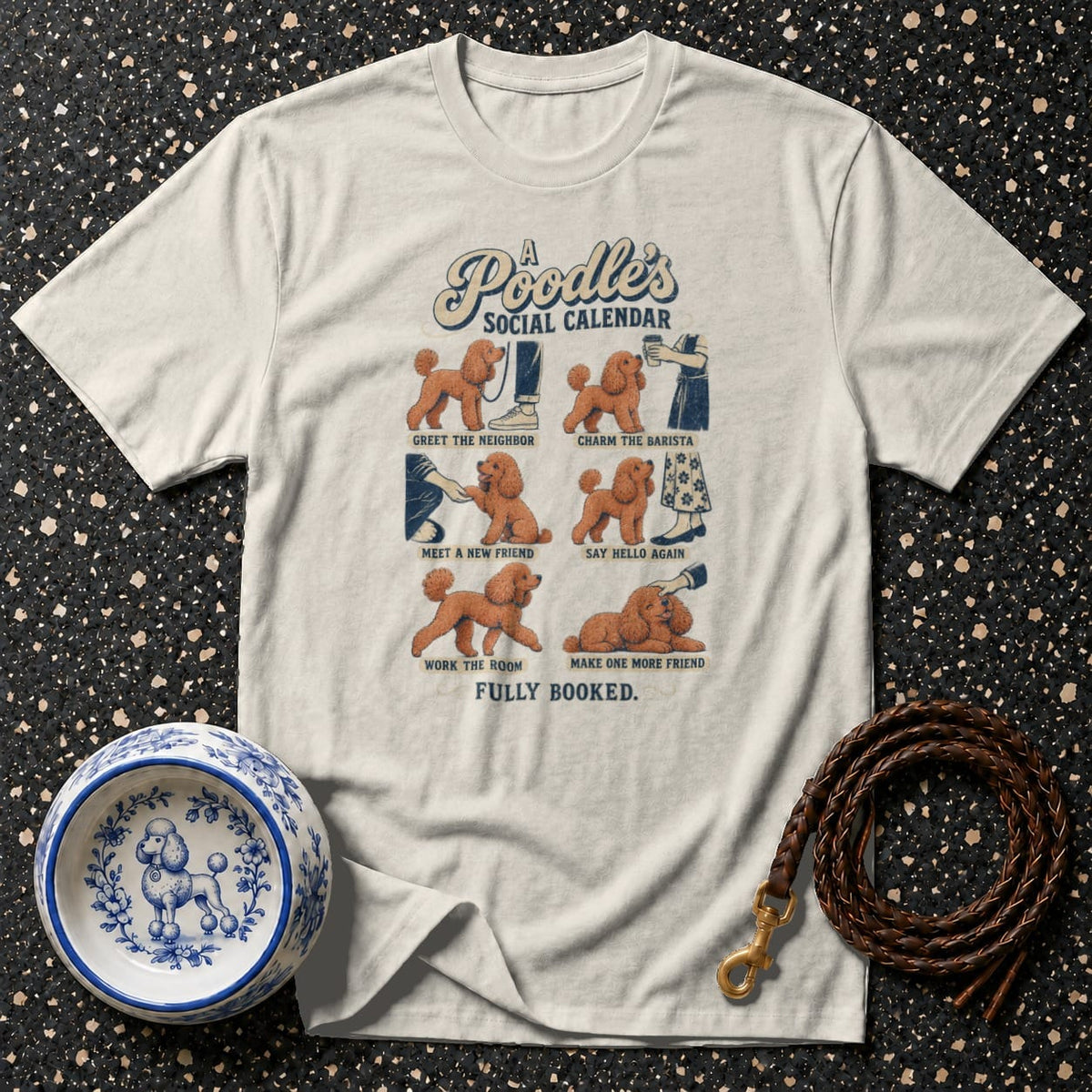 Light t-shirt with "A Poodle's Social Calendar" illustration of poodles and activities.
