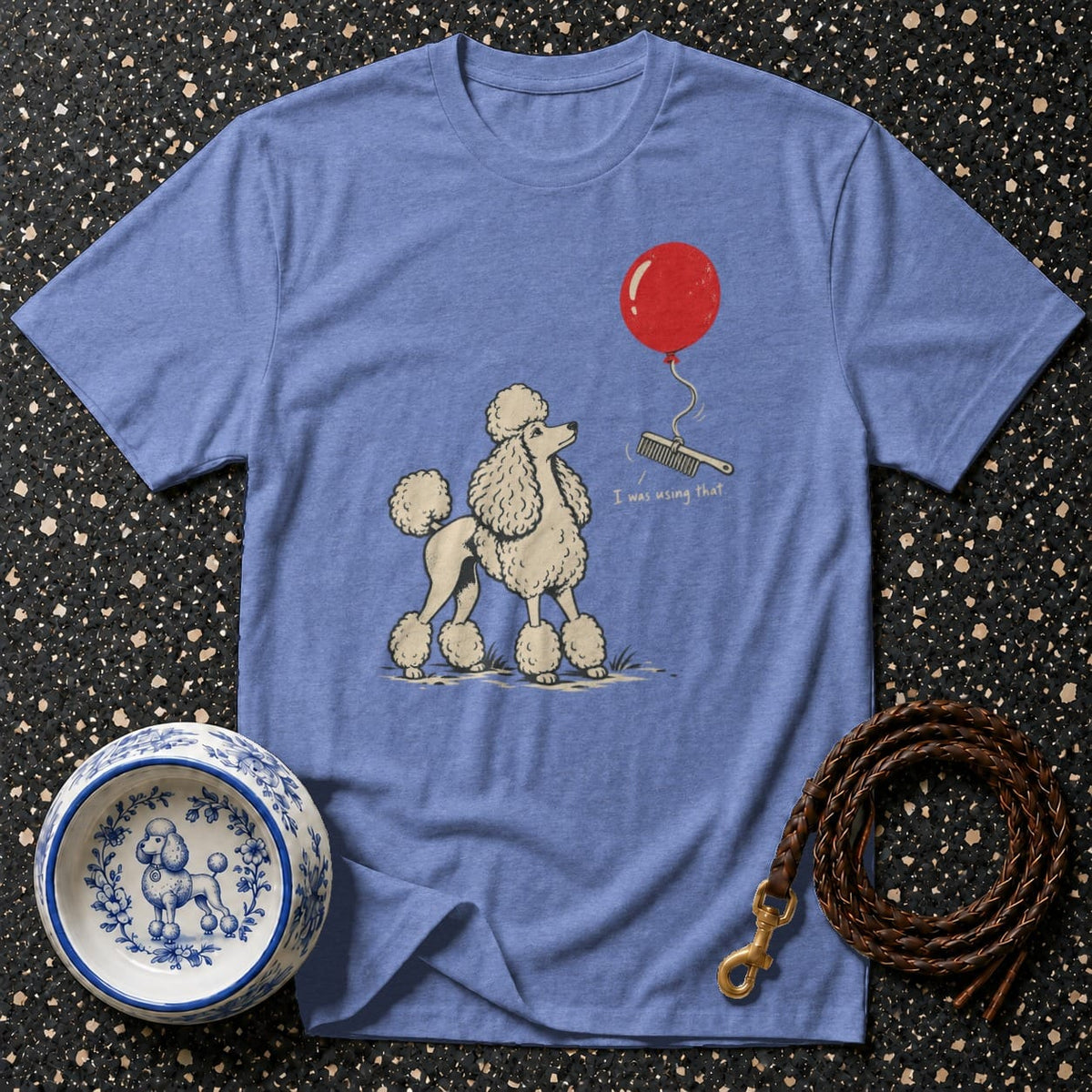 Blue t-shirt with graphic of poodle, balloon, comb, and text.