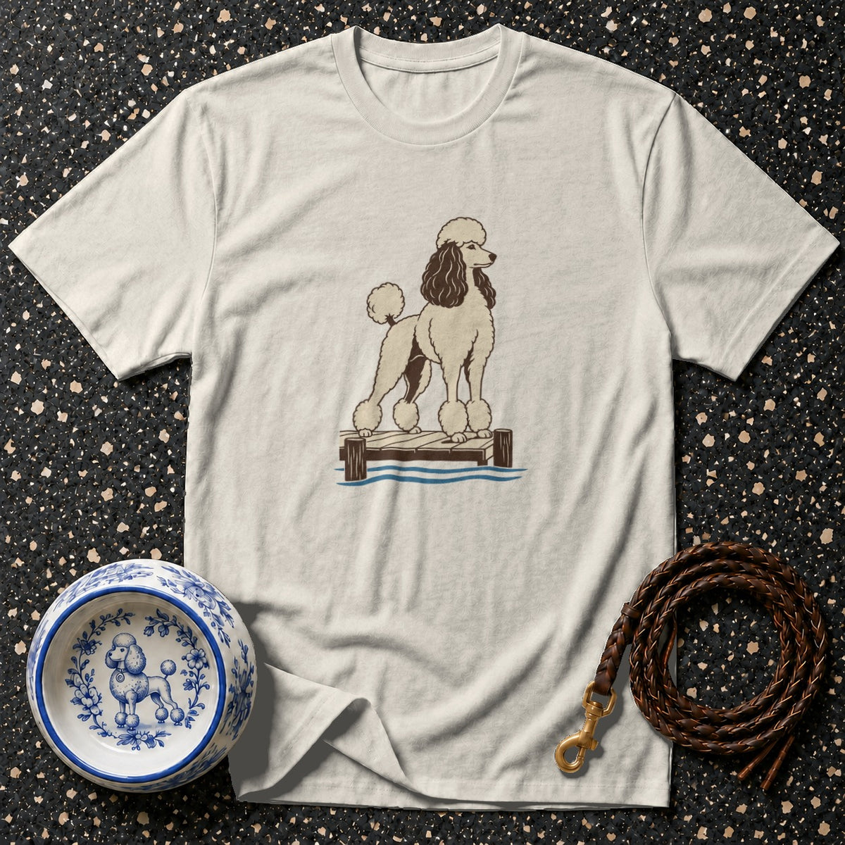 T-shirt with a graphic of a poodle on a dock and a decorative dog bowl.