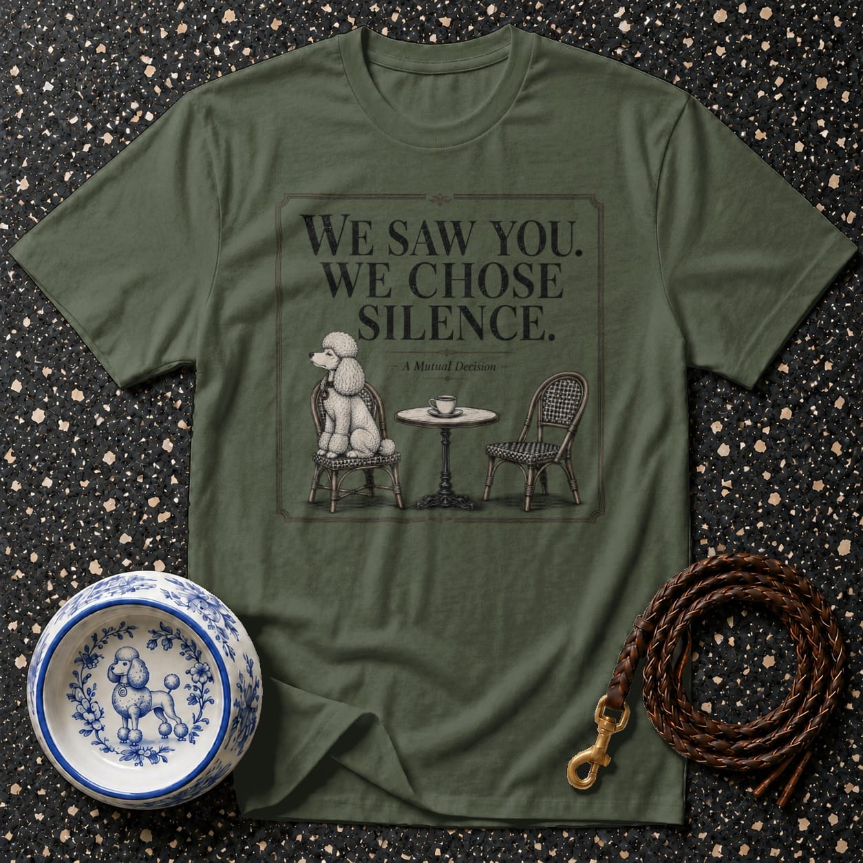 Olive green t-shirt with "We Saw You. We Chose Silence." text and poodle illustration.