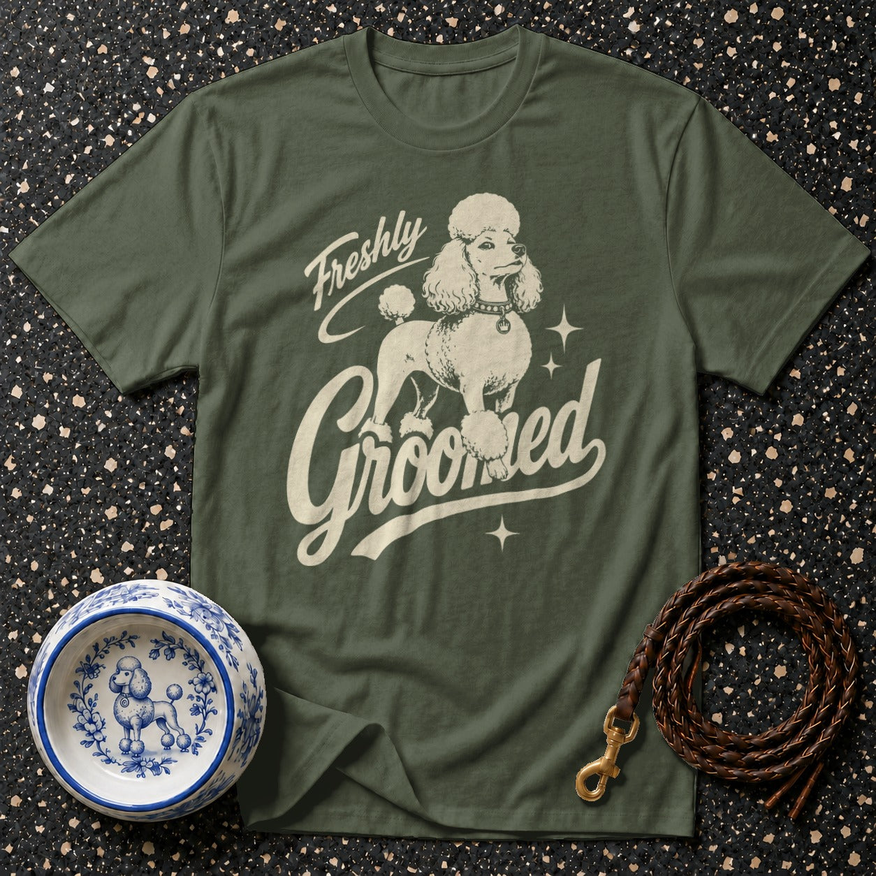Green t-shirt with a cream poodle graphic and text "Freshly Groomed."