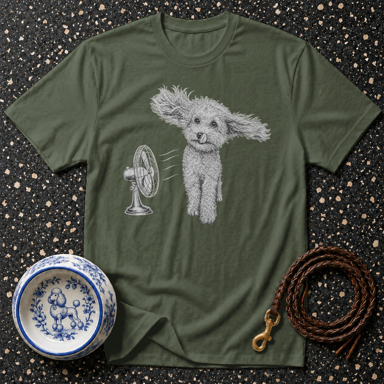 Green t-shirt with a drawing of a poodle with its ears blowing in the wind from a fan.