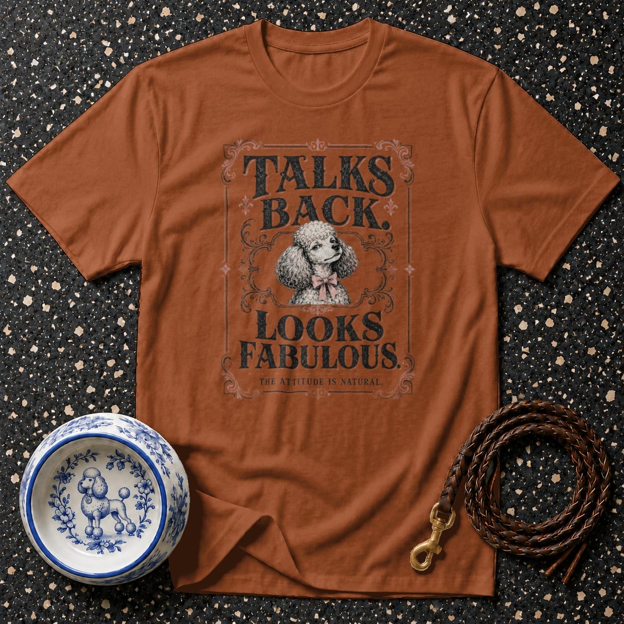 Brown t-shirt with poodle graphic and text: "TALKS BACK. LOOKS FABULOUS. THE ATTITUDE IS NATURAL."