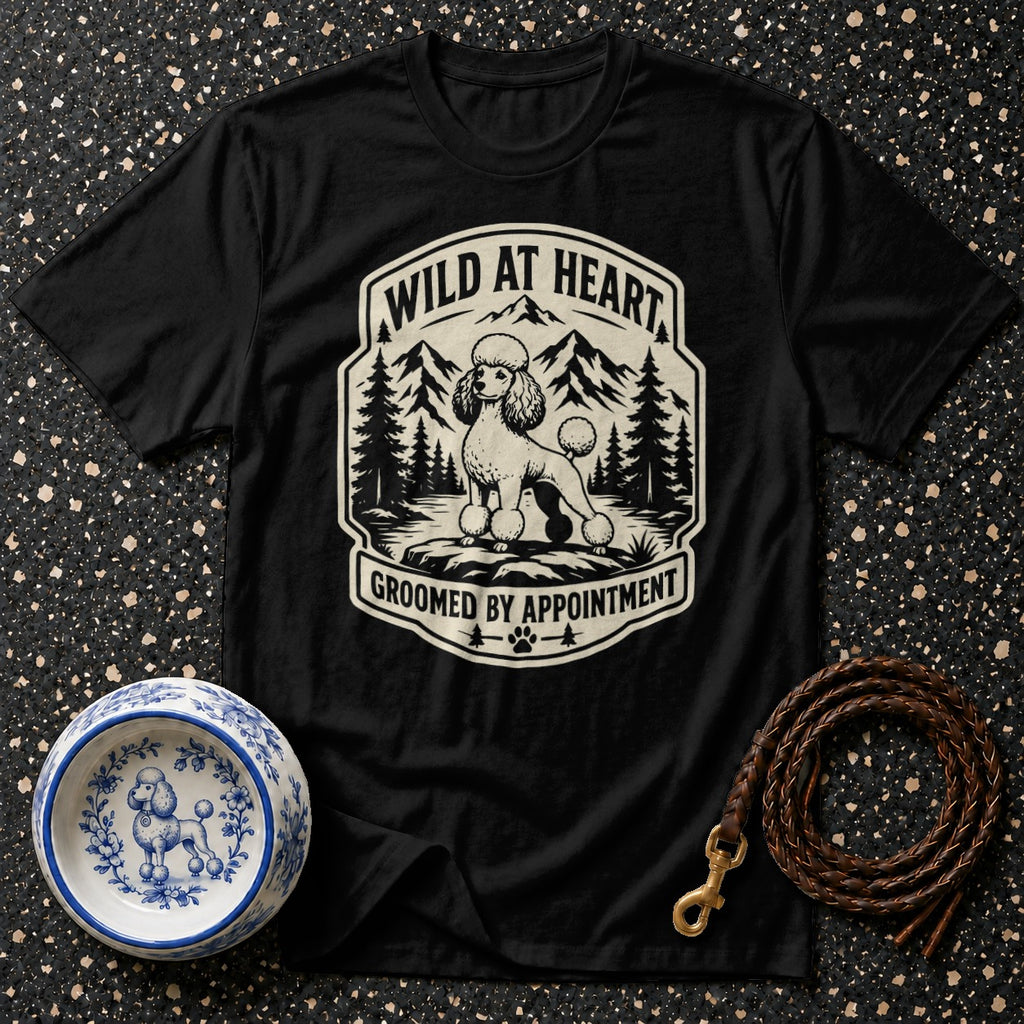 Black t-shirt with a vintage graphic of a poodle in a mountain landscape, reading "WILD AT HEART GROOMED BY APPOINTMENT".