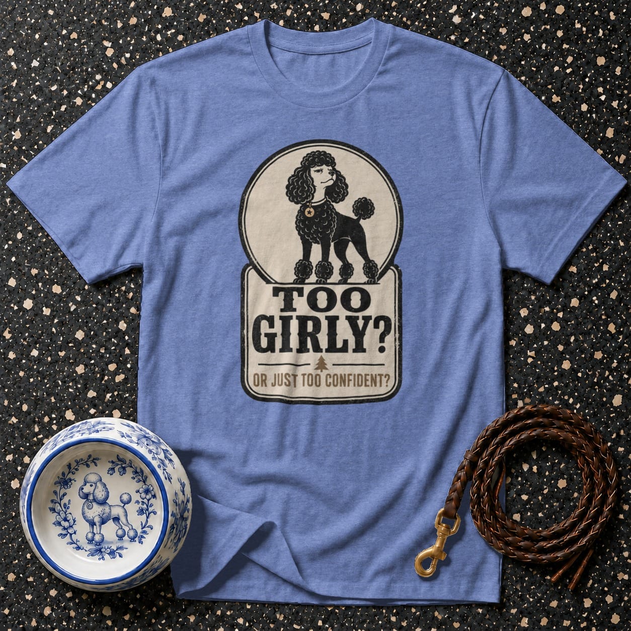 Blue t-shirt with a poodle graphic and text "TOO GIRLY? OR JUST TOO CONFIDENT?".