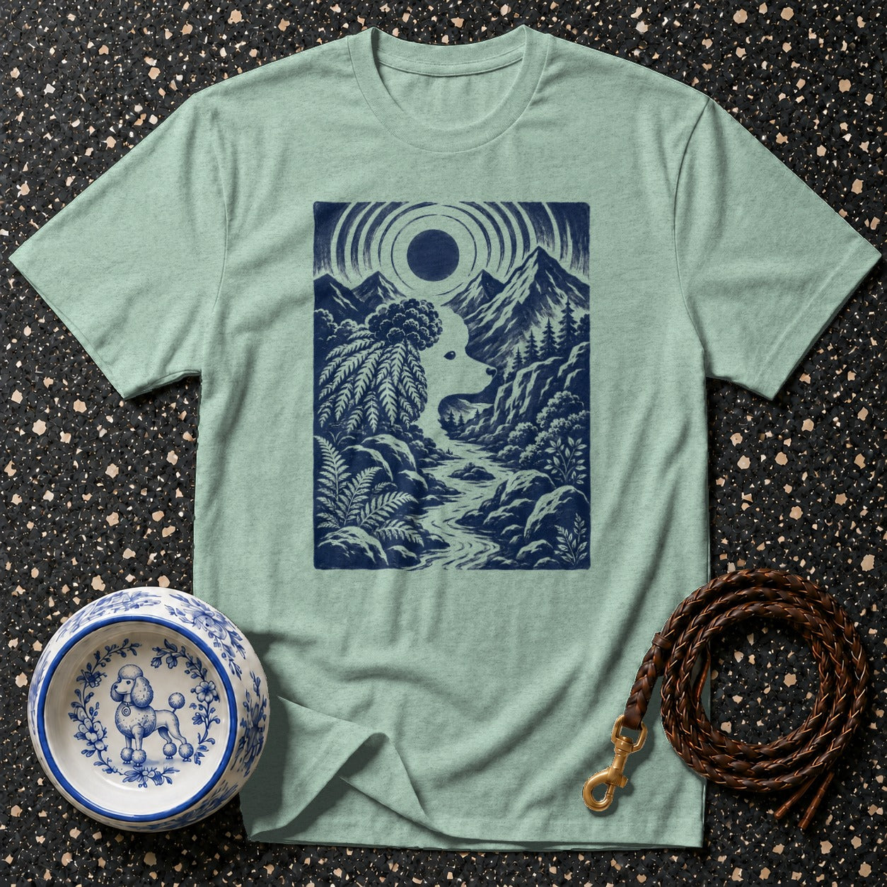 Light green t-shirt with dark blue nature scene featuring a dog's silhouette.