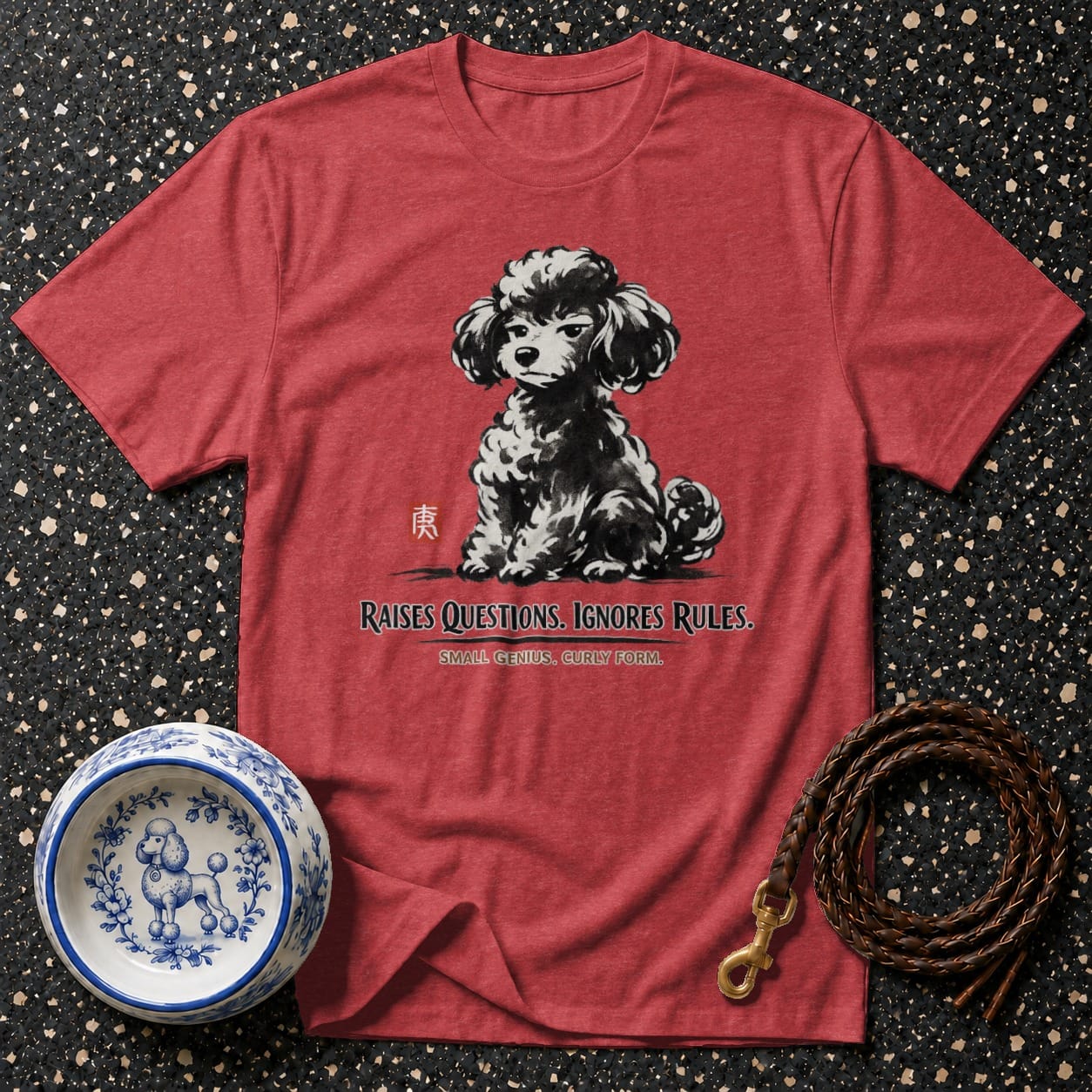 Red t-shirt with drawing of a poodle and text "RAISES QUESTIONS. IGNORES RULES."